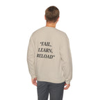 Man wearing a beige sweatshirt with 'FAIL, LEARN, RELOAD' text on the back against a white background